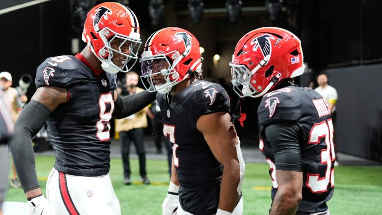 Atlanta Falcons running back Bijan Robinson (7) celebrates his rushing touchdown with tight end Kyle Pitts (8) and cornerback Natrone Brooks (35) during the first half of an NFL football game against the Buffalo Bills, Monday, Oct. 13, 2025, in Atlanta. (Mike Stewart/AP)