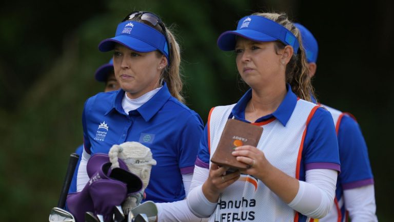 Brooke Henderson, left, of the World team stands with her caddie and sister, Brittany Henderson, on the ninth hole during the pool B match against South Korea team for the LPGA International Crown golf tournament at the New Korea Country Club in Goyang, South Korea, Friday, Oct. 24, 2025. (Lee Jin-man/AP Photo)