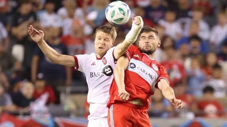 Toronto FC defender Sigurd Rosted, left, and Chicago Fire forward Hugo Cuypers, right, battle for control of the ball during the second half of an MLS soccer match Saturday, Oct. 4, 2025, in Chicago. (Talia Sprague/AP)