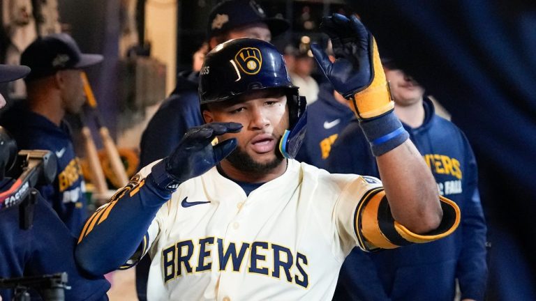 Milwaukee Brewers' Jackson Chourio celebrates in the dugout after scoring against the Los Angeles Dodgers during the first inning in Game 2 of baseball's National League Championship Series, Tuesday, Oct. 14, 2025, in Milwaukee. (Brynn Anderson/AP Photo)