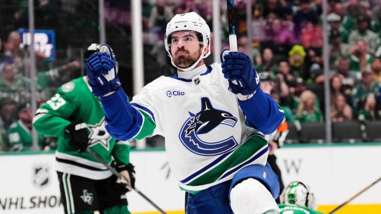 Vancouver Canucks right wing Conor Garland (8) celebrates after scoring in the second period of an NHL hockey game against the Dallas Stars Thursday, Oct. 16, 2025, in Dallas. (Tony Gutierrez/AP)