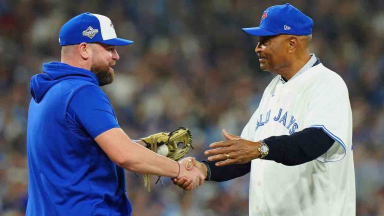 Former Blue Jays manager Cito Gaston, right, shakes hands with current skipper John Schneider after throwing the ceremonial first pitch before Game 1 of Major League Baseball's World Series between the Blue Jays and Los Angeles Dodgers in Toronto on Oct. 24, 2025. (Frank Gunn/CP)