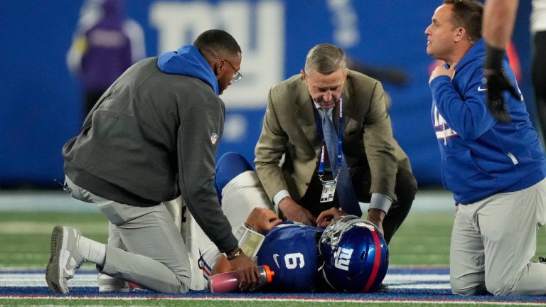 New York Giants' Jaxson Dart is helped on the field during the second half of an NFL football game against the Philadelphia Eagles Thursday, Oct. 9, 2025, in East Rutherford, N.J. (Yuki Iwamura/AP)