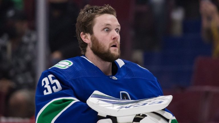 Canucks goaltender Thatcher Demko reacts after using smelling salts before a game against the Carolina Hurricanes in Vancouver on Sunday, Dec. 12, 2021. (Darryl Dyck/CP)