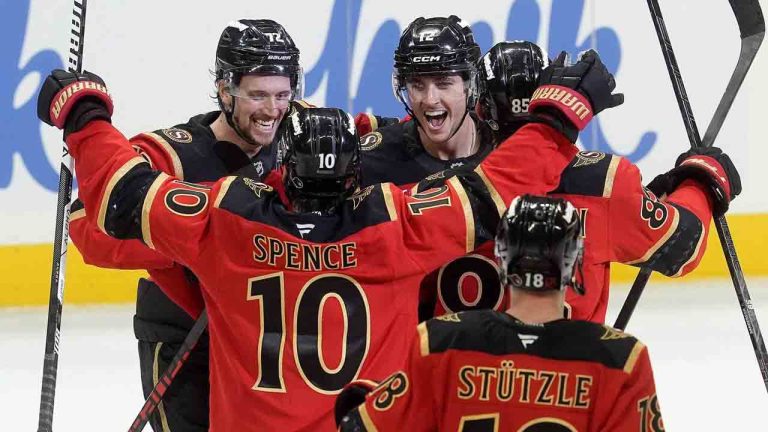 Ottawa Senators centre Shane Pinto (12)celebrates his game winning goal in a shootout with teammates centre Tim Stutzle (18), defenceman Jordan Spence (10) and defenceman Thomas Chabot (72) in NHL action against the Seattle Kraken in Ottawa, Thursday, Oct. 16, 2025. (Adrian Wyld/CP)