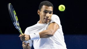Canada's Felix Auger-Aliassime returns the ball to Canada's Gabriel Diallo during their first round match at the Swiss Indoors tennis tournament at the St. Jakobshalle in Basel, Switzerland, Wednesday, Oct. 22, 2025. (Georgios Kefalas/Keystone via AP)
