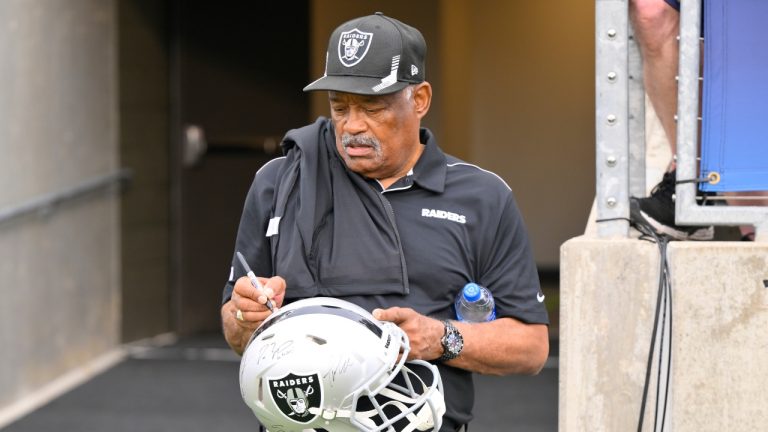 Former Oakland Raiders safety George Atkinson signs his autograph before the NFL football exhibition Hall of Fame Game between the Las Vegas Raiders and the Jacksonville Jaguars, Aug. 4, 2022, in Canton, Ohio. (David Richard/AP)