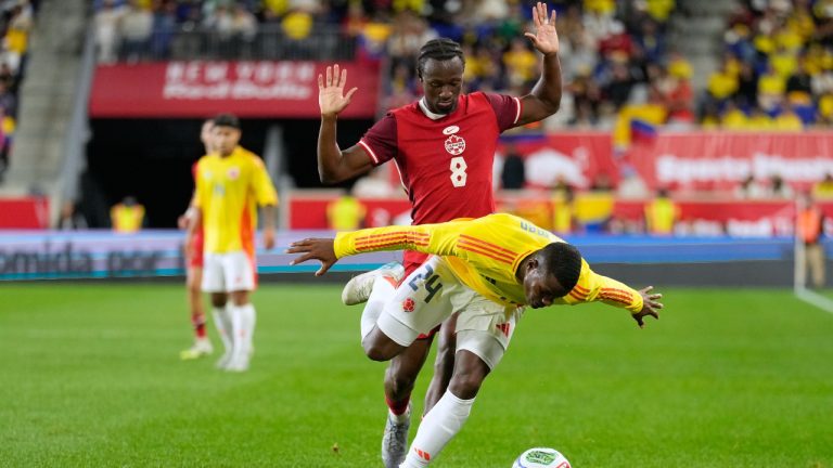Canada's Ismaël Koné, top and Colombia's Andres Felipe Roman battle for the ball during the first half of a friendly soccer match in Harrison, N.J., Tuesday, Oct. 14, 2025. (Seth Wenig/AP)