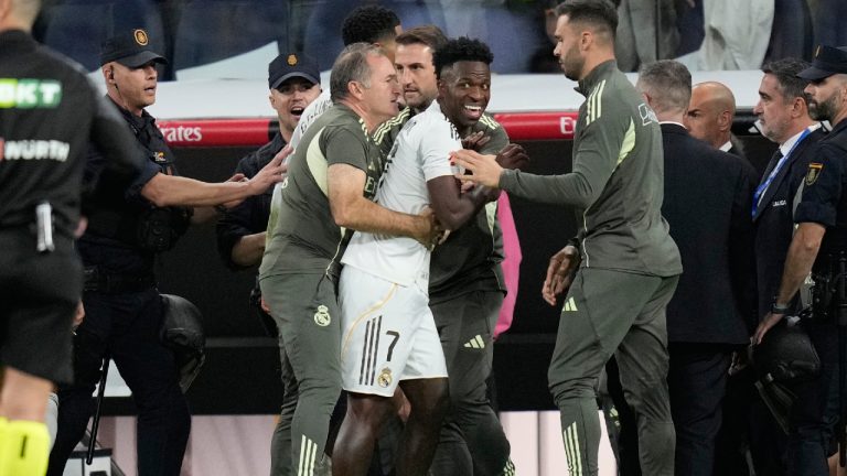 Real Madrid's Vinicius Junior is restrained by coaching staff duringa post match scuffle at La Liga soccer match between Real Madrid and Barcelona in Madrid, Spain, Sunday, Oct. 26, 2025. (Bernat Armangue/AP)