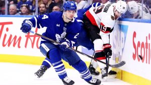 Toronto Maple Leafs' Scott Laughton (24) and Ottawa Senators' Drake Batherson (19) battle for the puck during third period NHL playoff action in Toronto, on Tuesday, April 22, 2025. (Cole Burston/THE CANADIAN PRESS)