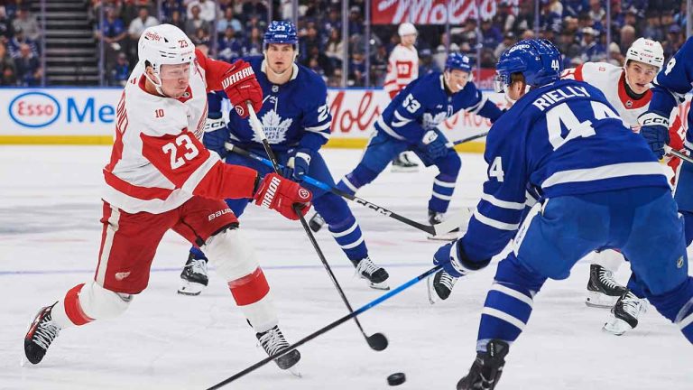 Detroit Red Wings' Lucas Raymond (23) fires a shot past Toronto Maple Leafs' Morgan Rielly (44) during first period NHL hockey action. (Sammy Kogan/CP)