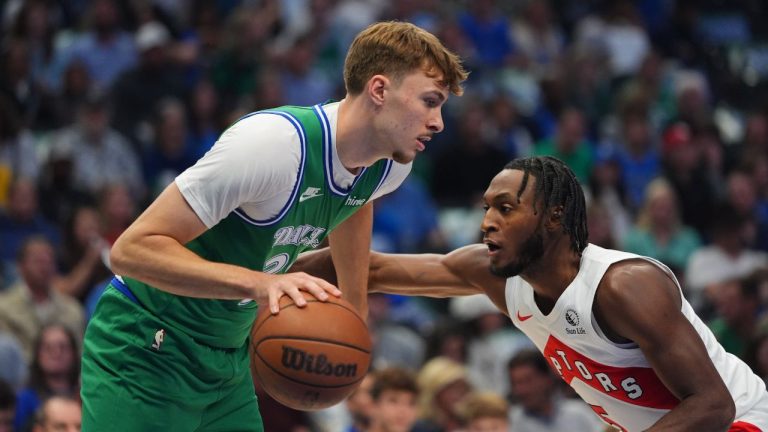 Dallas Mavericks forward Cooper Flagg, left, moves the ball against Toronto Raptors guard Immanuel Quickley, right, during the first half of an NBA basketball game basketball game in Dallas, Sunday, Oct. 26, 2025. (LM Otero/AP)