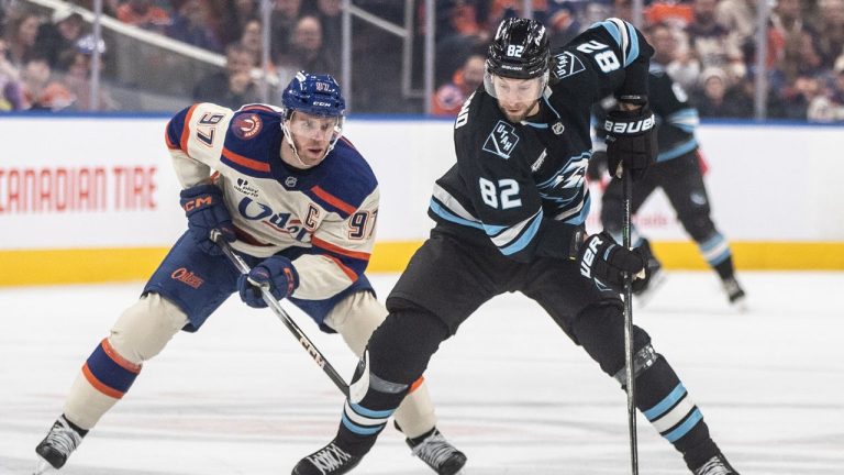 Utah Mammoth's Kevin Stenlund (82) is chased by Edmonton Oilers' Connor McDavid (97) during first period NHL action, in Edmonton on Tuesday, October 28, 2025. (Jason Franson/THE CANADIAN PRESS)
