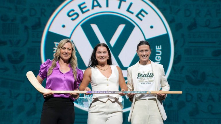 PWHL Seattle select forward Jenna Buglioni, centre, from Port Moody, B.C. during the first round of PWHL draft in Ottawa, Tuesday June 24, 2025. (Adrian Wyld/CP)