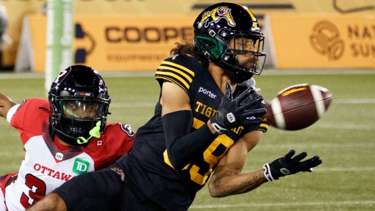 Hamilton Tiger-Cats wide receiver Kenny Lawler (89) makes a catch for a first down while defended by Ottawa Redblacks defensive back Cameron Lockridge (39) during first half CFL football game action in Hamilton, Ont. on Friday, October 24, 2025. (Peter Power/CP)