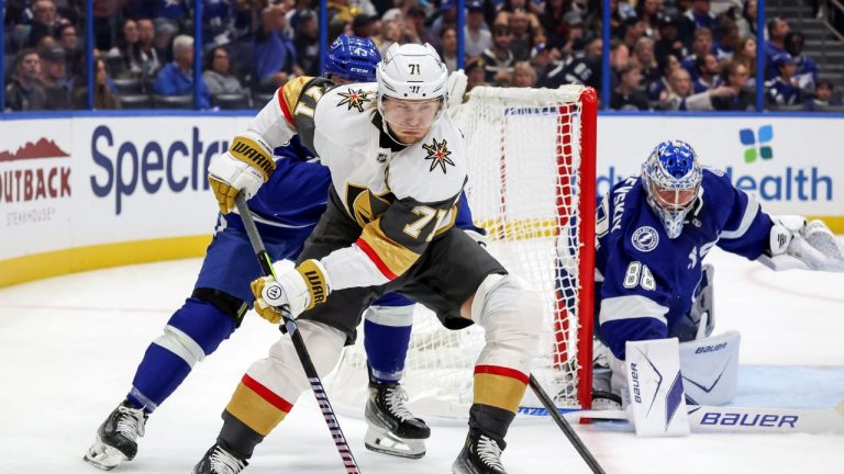 Vegas Golden Knights' William Karlsson (71) takes the puck behind Tampa Bay Lightning goaltender Andrei Vasilevskiy, right, during the first period of an NHL hockey game Sunday, Oct. 26, 2025, in Tampa, Fla. (Mike Carlson/AP)