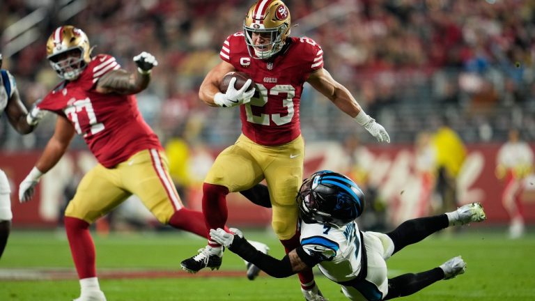 San Francisco 49ers running back Christian McCaffrey is tackled by Carolina Panthers safety Tre'Von Moehrig during the first half an NFL football game, Monday, Nov. 24, 2025, in Santa Clara, Calif. (AP Photo/Godofredo A. Vásquez)