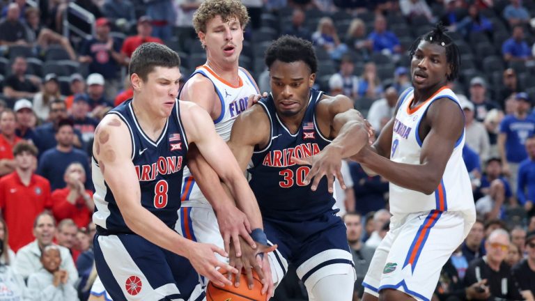 Arizona forwards Ivan Kharchenkov (8) and Tobe Awaka (30) contest for a rebound against Florida center Micah Handlogten, second from left, during the first half of an NCAA college basketball game, Monday, Nov. 3, 2025, in Las Vegas. (AP Photo/Ian Maule)