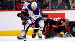 Edmonton Oilers' Connor McDavid (97) controls the puck against Carolina Hurricanes' Jordan Staal (11) during the second period of an NHL hockey game in Raleigh, N.C., Saturday, March 1, 2025. (Karl DeBlaker/AP)