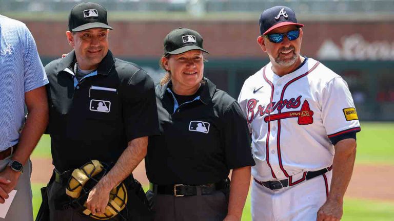 Umpires David Rackley, left, and Jan Pawol, center, pose for a photo with Atlanta Braves bench coach/infield coach Walt Weiss, right, before the start of the first baseball game of a doubleheader between the Atlanta Braves and Miami Marlins, Saturday, Aug. 9, 2025, in Atlanta. (Colin Hubbard/AP)