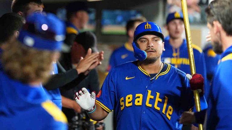 Seattle Mariners' Josh Naylor holds the trident in the dugout after hitting a solo home run against the Athletics during the seventh inning of a baseball game Friday, Aug. 22, 2025, in Seattle. (Lindsey Wasson/AP)
