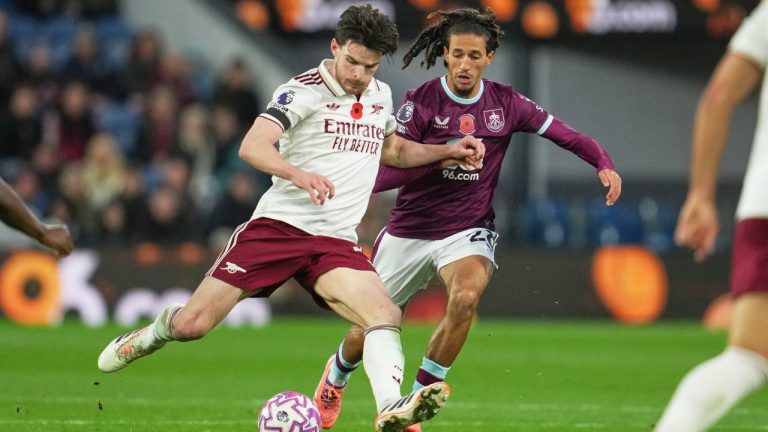 Arsenal's Declan Rice, left, challenges for the ball with Burnley's Hannibal Mejbri during the English Premier League soccer match between Burnley and Arsenal in Burnley, England, Saturday, Nov. 1, 2025. (AP Photo/Jon Super)