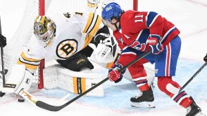 Montreal Canadiens' Brendan Gallagher (11) moves in on Boston Bruins goaltender Jeremy Swayman during first period NHL hockey action in Montreal, Saturday, Nov. 15, 2025. (Graham Hughes/CP)