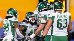 Saskatchewan Roughriders' A.J. Ouellette (45), middle, celebrates his touchdown with teammates while taking on the Montreal Alouettes during first half CFL football action at the 112th Grey Cup, in Winnipeg on Sunday, Nov. 16, 2025. (Darryl Dyck/CP)