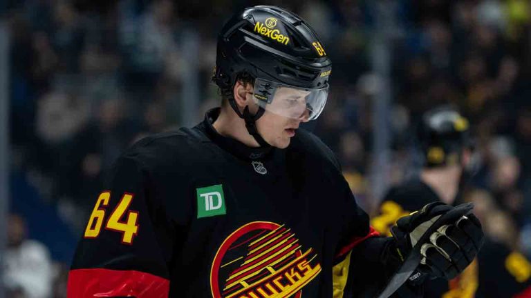 Vancouver Canucks' David Kampf (64) waits for a face off against the Dallas Stars during the second period of an NHL hockey game in Vancouver, on Thursday, November 20, 2025. (Ethan Cairns/CP)