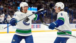 Vancouver Canucks right wing Brock Boeser (6) celebrates his goal against the Tampa Bay Lightning with left wing Kiefer Sherwood (44) during the third period of an NHL hockey game Sunday, Nov. 16, 2025, in Tampa, Fla. (Chris O'Meara/AP)