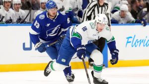 Vancouver Canucks left wing Drew O'Connor (18) breaks out ahead of Tampa Bay Lightning centre Gage Goncalves (93) during the first period of an NHL hockey game Sunday, Nov. 16, 2025, in Tampa, Fla. (Chris O'Meara/AP)