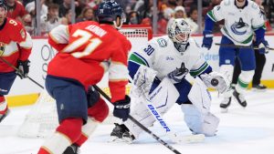 Vancouver Canucks goaltender Jiri Patera (30) defends as Florida Panthers centre Luke Kunin (71) attempts to score during the second period of an NHL hockey game, Monday, Nov. 17, 2025, in Sunrise, Fla. (Rebecca Blackwell/AP)
