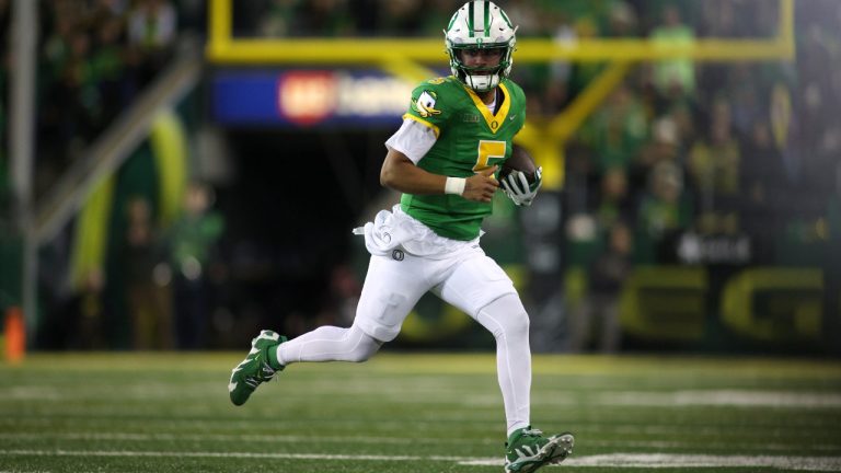 Oregon quarterback Dante Moore (5) runs with the ball during the first half of an NCAA college football game against Minnesota, Friday, Nov. 14, 2025, in Eugene, Ore. (Lydia Ely/AP)