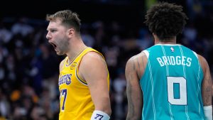 Los Angeles Lakers guard Luka Doncic celebrates after scoring as Charlotte Hornets forward Miles Bridges looks on during the second half of an NBA basketball game Monday, Nov. 10, 2025, in Charlotte, N.C. (Chris Carlson/AP)