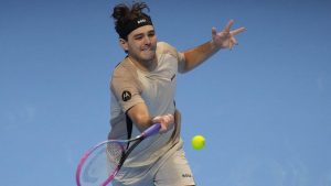 United States' Taylor Fritz returns the ball to Italy's Lorenzo Musetti during their singles tennis match of the ATP World Tour Finals, in Turin, Italy, Monday, Nov. 10, 2025. (AP/Antonio Calanni)