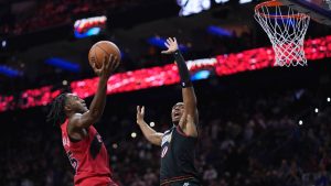 Toronto Raptors' Immanuel Quickley, left, goes up for a shot against Philadelphia 76ers' Tyrese Maxey during the second half of an NBA basketball game Saturday, Nov. 8, 2025, in Philadelphia. (Matt Slocum/AP)