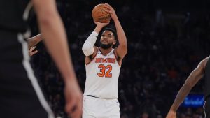 New York Knicks' Karl-Anthony Towns shoots over Brooklyn Nets defenders during the first half of an NBA game Sunday, Nov. 9, 2025, at Madison Square Garden in New York. (AP/Frank Franklin II)