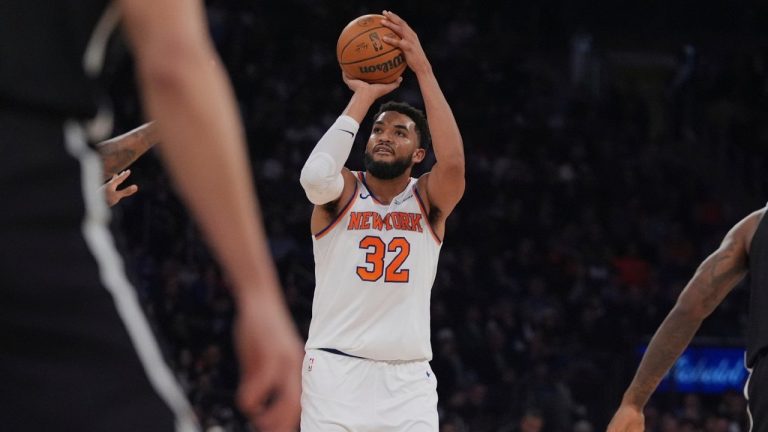 New York Knicks' Karl-Anthony Towns shoots over Brooklyn Nets defenders during the first half of an NBA game Sunday, Nov. 9, 2025, at Madison Square Garden in New York. (AP/Frank Franklin II)