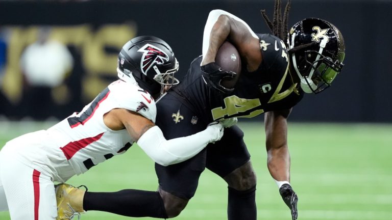 Atlanta Falcons safety Xavier Watts tackles New Orleans Saints running back Alvin Kamara in the first half of an NFL game, Sunday, Nov. 23, 2025, in New Orleans. (AP/Gerald Herbert)
