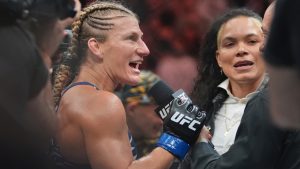 Kayla Harrison, left, talks to Amanda Nunes after her women's bantamweight title win over Julianna Pena at UFC 316. (Frank Franklin II/AP)