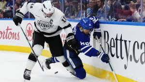 Los Angeles Kings' Anze Kopitar (11) checks Toronto Maple Leafs' William Nylander (88) during second period NHL hockey in Toronto on Thursday, November 13, 2025. (Nathan Denette/CP)