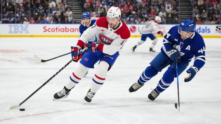 Montreal Canadiens' Josh Anderson (17) skates with the puck as Toronto Maple Leafs' Morgan Rielly (44) follows during first period NHL hockey action in Toronto on Saturday, April 12, 2025. (Arlyn McAdorey/CP)