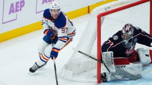 Edmonton Oilers centre Connor McDavid (97) brings the pucks around the net behind Columbus Blue Jackets goaltender Jet Greaves (73) in the first period of an NHL game in Columbus, Thursday, Nov. 13, 2025. (Sue Ogrocki/AP)