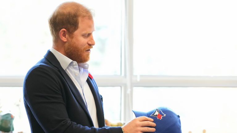 Prince Harry received a Toronto Blue Jays hat as he meets with some of Canada's oldest veterans, joining them in a creative arts program at Sunnybrook Hospital's veterans centre in Toronto, Thursday, Nov. 6, 2025. (Nathan Denette/CP)
