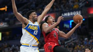 Toronto Raptors forward Scottie Barnes (4) shoots under Indiana Pacers center Tony Bradley (13) during the first half of an NBA basketball game in Indianapolis, Saturday, Nov. 15, 2025. (AP Photo/AJ Mast)