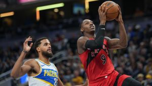 Toronto Raptors forward RJ Barrett (9) shoots in front of Indiana Pacers forward Jeremiah Robinson-Earl during the first half of an NBA basketball game in Indianapolis, Saturday, Nov. 15, 2025. (AP Photo/AJ Mast)