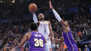 Oklahoma City Thunder guard Shai Gilgeous-Alexander (2) looks to shoot between Los Angeles Lakers guard Marcus Smart (36) and forward Rui Hachimura, right, during the first half of an NBA basketball game Wednesday, Nov. 12, 2025, in Oklahoma City. (Nate Billings/AP)