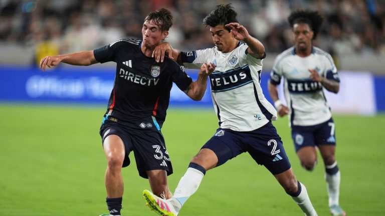 San Diego FC defender Oscar Verhoeven, left, battles Vancouver Whitecaps defender Mathías Laborda for the ball during the first half of an MLS soccer match Saturday, July 19, 2025, in San Diego. (Gregory Bull/AP)