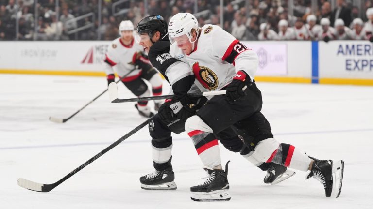 Los Angeles Kings left wing Trevor Moore (12) and Ottawa Senators left wing Fabian Zetterlund (20) chase the puck during the third period of an NHL hockey game Monday, Nov. 24, 2025, in Los Angeles. (AP Photo/Jae C. Hong)