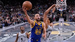Golden State Warriors guard Stephen Curry (30) drives to the basket against San Antonio Spurs forward Victor Wembanyama (1) during the second half of an NBA Cup basketball game in San Antonio, Friday, Nov. 14, 2025. (AP Photo/Eric Gay)